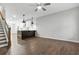 Open-concept living room and kitchen with hardwood floors and a ceiling fan at 772 Aerial Se Way, Atlanta, GA 30312