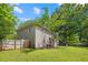 Wide shot of the backyard with a lush green lawn and wood fence at 908 Lance Cir, Lawrenceville, GA 30043
