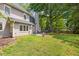 View of the house, patio, and green lawn in a spacious fenced backyard at 908 Lance Cir, Lawrenceville, GA 30043