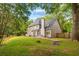 Expansive backyard featuring a patio, lush green grass, and wood fence at 908 Lance Cir, Lawrenceville, GA 30043
