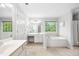 Primary bathroom with soaking tub, dual sinks, and bright natural light at 908 Lance Cir, Lawrenceville, GA 30043