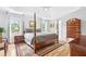 Bedroom features a four-poster bed, wooden floors, and lots of natural light at 908 Lance Cir, Lawrenceville, GA 30043
