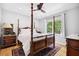 Cozy bedroom featuring a four-poster bed and a large window letting in natural light at 908 Lance Cir, Lawrenceville, GA 30043