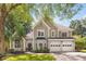 Charming two-story home with gray stucco exterior, well-manicured landscaping, and a two-car garage at 908 Lance Cir, Lawrenceville, GA 30043