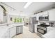 Efficient kitchen with stainless steel appliances, a breakfast bar, and seamless transition to the dining area at 908 Lance Cir, Lawrenceville, GA 30043