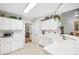 Well-lit kitchen boasts white cabinets, modern appliances, and a view of the living room at 908 Lance Cir, Lawrenceville, GA 30043