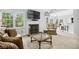 Cozy living room with a fireplace, large TV, and comfortable seating arrangement at 908 Lance Cir, Lawrenceville, GA 30043