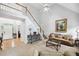 Spacious living room with high ceilings, staircase, and large windows for natural light at 908 Lance Cir, Lawrenceville, GA 30043
