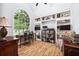 Bright study with large arched window, custom built-in shelving, and hardwood floors at 908 Lance Cir, Lawrenceville, GA 30043