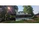 Backyard featuring a deck, sunroom, and wooded surroundings at 95 Willow Tree Ter, Covington, GA 30016