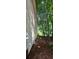 View of the side of the home with a small window and wooded area at 95 Willow Tree Ter, Covington, GA 30016