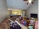 Cluttered living room featuring a ceiling fan, vaulted ceiling, and open floor plan at 95 Willow Tree Ter, Covington, GA 30016