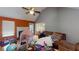 Untidy living room with a fireplace, wood floors, and an orange accent wall at 95 Willow Tree Ter, Covington, GA 30016
