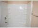 Bathroom features a white tiled shower-tub combo and neutral paint at 10103 Waldrop Pl, Decatur, GA 30034