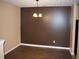 An empty dining room featuring hardwood floors, modern lighting, and neutral paint colors at 10103 Waldrop Pl, Decatur, GA 30034