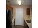 A functional kitchen design with wooden cabinets, light countertops, and a black refrigerator at 10103 Waldrop Pl, Decatur, GA 30034