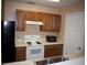 The kitchen features wooden cabinets, white countertops, and appliances at 10103 Waldrop Pl, Decatur, GA 30034