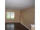 Bright living room features hardwood floors, a large window, and neutral-colored walls at 10103 Waldrop Pl, Decatur, GA 30034