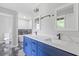 Modern bathroom featuring a double vanity with blue cabinets, two mirrors, and black hardware at 4000 Brittan Glade Trl, Snellville, GA 30039
