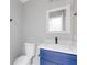 Stylish half bath with blue vanity and white quartz countertop at 4000 Brittan Glade Trl, Snellville, GA 30039