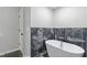 Modern bathroom featuring a free standing tub with black marble accents at 4000 Brittan Glade Trl, Snellville, GA 30039