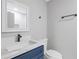Modern bathroom features blue vanity with white countertop and square sink at 4000 Brittan Glade Trl, Snellville, GA 30039