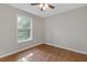 Cozy bedroom with hardwood flooring and large window, offering plenty of natural light at 4000 Brittan Glade Trl, Snellville, GA 30039