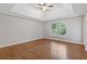Spacious bedroom featuring a trey ceiling, hardwood flooring, and a large window at 4000 Brittan Glade Trl, Snellville, GA 30039