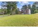 Inviting two-story home with a spacious front yard and mature trees creating a peaceful setting at 4000 Brittan Glade Trl, Snellville, GA 30039