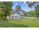 The home's rear exterior with lush backyard, offering a serene and private outdoor space at 4000 Brittan Glade Trl, Snellville, GA 30039