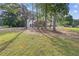Picturesque lot with mature trees surrounding the home and a lush green lawn at 4000 Brittan Glade Trl, Snellville, GA 30039