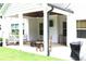 Covered back porch offering comfortable seating, a swing, and a ceiling fan for relaxation at 688 Harmony Rd, Temple, GA 30179