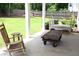 Back porch featuring comfortable seating and a swing with a lush green lawn at 688 Harmony Rd, Temple, GA 30179