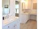 Bright bathroom featuring tiled floors, a double sink vanity with stone countertops, and modern fixtures at 688 Harmony Rd, Temple, GA 30179