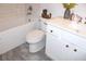 Bathroom featuring a tiled shower-tub combination and white vanity with gold knobs at 688 Harmony Rd, Temple, GA 30179