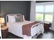 Cozy bedroom featuring a full bed with decorative pillows and natural light from a window at 688 Harmony Rd, Temple, GA 30179