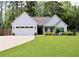Charming single-story home with a well-manicured lawn, attached two-car garage, and inviting front entrance at 688 Harmony Rd, Temple, GA 30179