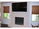 Living room fireplace with brick surround, mounted television, and natural light at 688 Harmony Rd, Temple, GA 30179