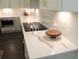 Modern kitchen countertop with white marble design, sleek cooktop, and stainless steel appliances at 688 Harmony Rd, Temple, GA 30179