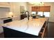 Bright, modern kitchen island featuring a white countertop and a black faucet at 688 Harmony Rd, Temple, GA 30179