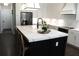 Spacious kitchen island with a white countertop, black base, and seating at 688 Harmony Rd, Temple, GA 30179