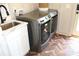 Laundry room with sink, cabinets, and modern front loading washer and dryer at 688 Harmony Rd, Temple, GA 30179