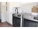 Laundry room featuring sink and modern washer and dryer with cabinets for storage at 688 Harmony Rd, Temple, GA 30179