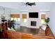 Open-concept living room with brick fireplace, large TV, and combined kitchen and dining area at 688 Harmony Rd, Temple, GA 30179