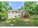 Rear exterior of home with a walkout basement and wooden deck on a sloped lot at 125 Ashbury Ct, Dallas, GA 30157