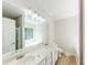 Bright bathroom featuring a double sink vanity and a large window above the soaking tub at 125 Ashbury Ct, Dallas, GA 30157
