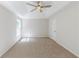 Spacious bedroom featuring a ceiling fan, neutral carpet, and a large window for plenty of natural light at 125 Ashbury Ct, Dallas, GA 30157
