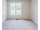 Bedroom featuring freshly painted walls, neutral carpet, and a bright window for natural light at 125 Ashbury Ct, Dallas, GA 30157