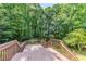 View from a wooden deck surrounded by lush green trees at 125 Ashbury Ct, Dallas, GA 30157