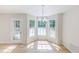 Cozy dining area features bright windows and a stylish chandelier at 125 Ashbury Ct, Dallas, GA 30157